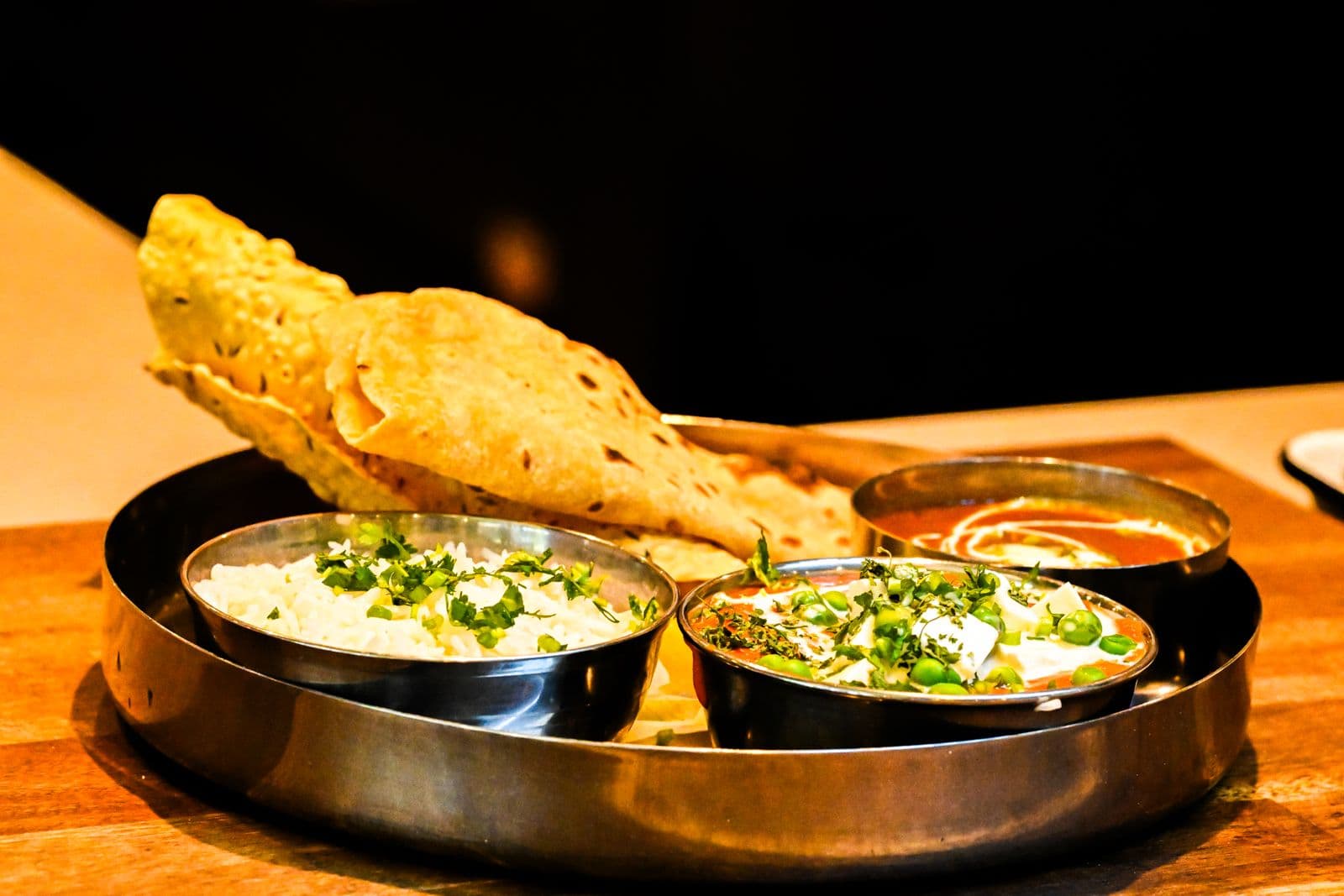 A thali of curries, rice and fresh naan